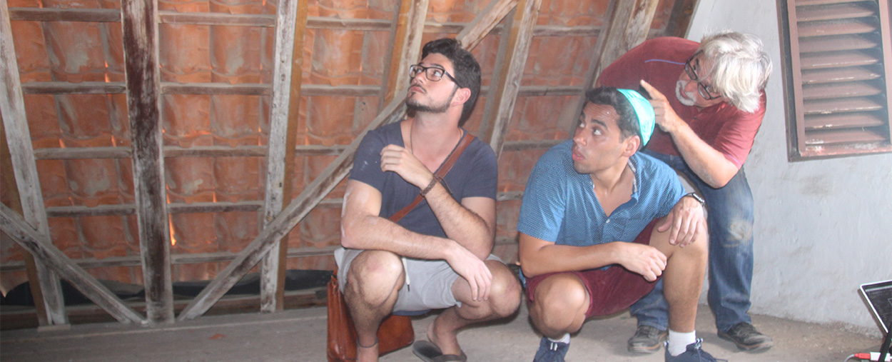 Professor Jorge Hernández points out attic features to Hector Valdivia Arrieta, left, and Hannan Vilchis-Zubizarreta, right.
