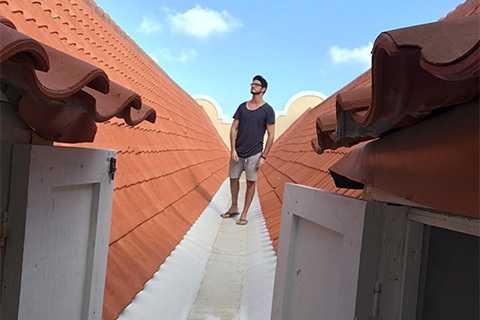 Hector Valdivia Arrieta walks the rooftop while exploring the attics.